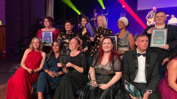 Kelly Johns - seated front row with long red hair - holding her Children & Young People award at the ceremony