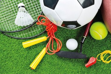 Various sport equipment on grass