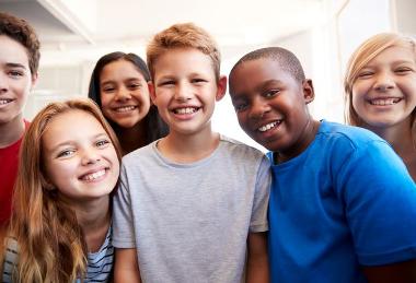 six children smile at the camera