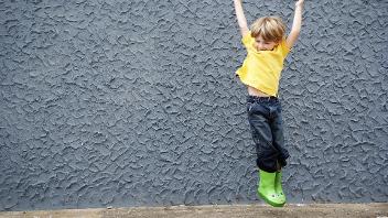 primary school child jumps in the air