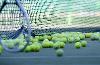 Tennis racket and balls on court