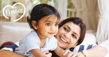 Woman with smiling baby, foster logo