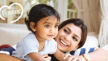 Woman with smiling baby, foster logo