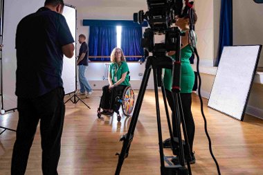 A film set, crew and actress, who's in a wheel chair