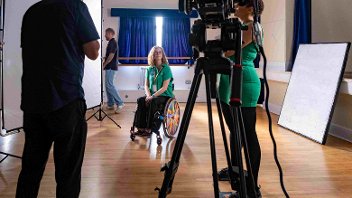 A film set, crew and actress, who's in a wheel chair