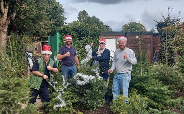 Staff from the Rural Activities Garden Centre with their home-grown Christmas trees