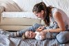 Cute small boy with Down syndrome playing with mother in home living room images