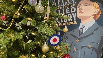 Christmas tree at the bunker with the 'Elsa' artwork behind