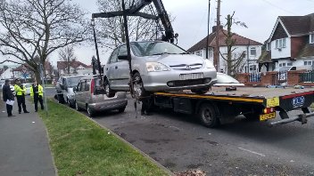 Cars being removed by enforcement officers