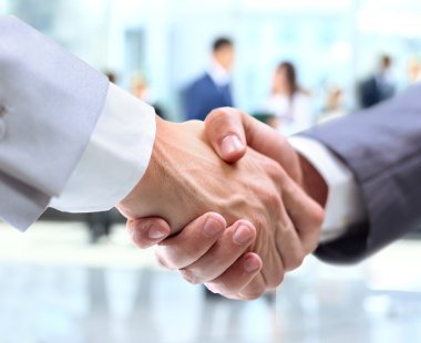 Two people shaking hands in smart work attire