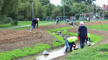 Community planting day at the flood measures in Elephant Park