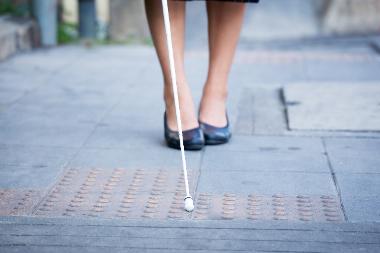 Image of a women with white cane