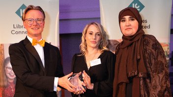 Gemma McCaffery, centre, and Franka Aichour receive their award from Libraries Connected 