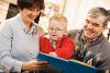 Child reading with family
