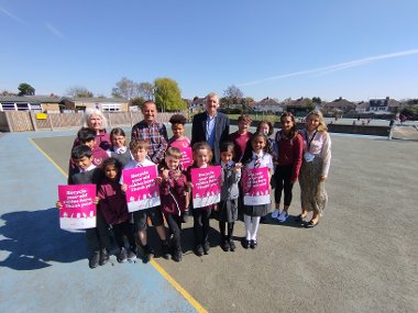 Cllr Eddie Lavery with Neil Wilkey, Headteacher at Newnham Junior School, staff and pupils