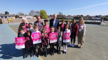 Cllr Eddie Lavery with Neil Wilkey, Headteacher at Newnham Junior School, staff and pupils