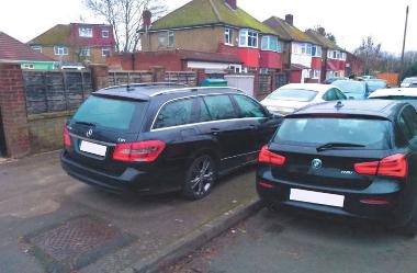 Cars parked outside the home of the Prasads