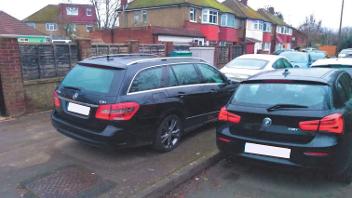 Cars parked outside the home of the Prasads