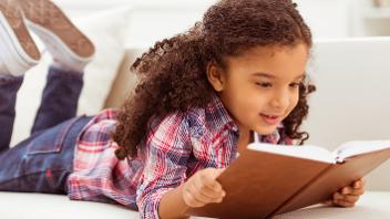 Young girl reading a book